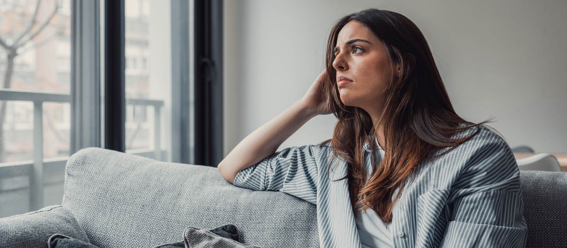 Worried Woman Contemplating Four Beliefs that Keep You Sick