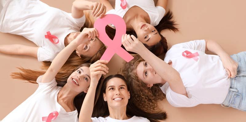 Women holding pink ribbon, representing breast cancer awareness, celebrating Healing After Cancer Detox, Nutrition and the Path to Thriving