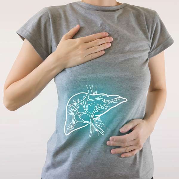 Woman holding her chest and stomach with an illuminated liver graphic superimposed on her shirt.