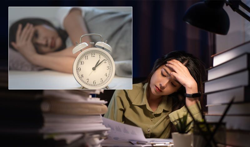 A woman feeling tired at work and awake at night, experiencing classic symptoms of Nervous System Dysregulation A woman is tired at work and awake at night, experiencing classic symptoms of Nervous System Dysregulation