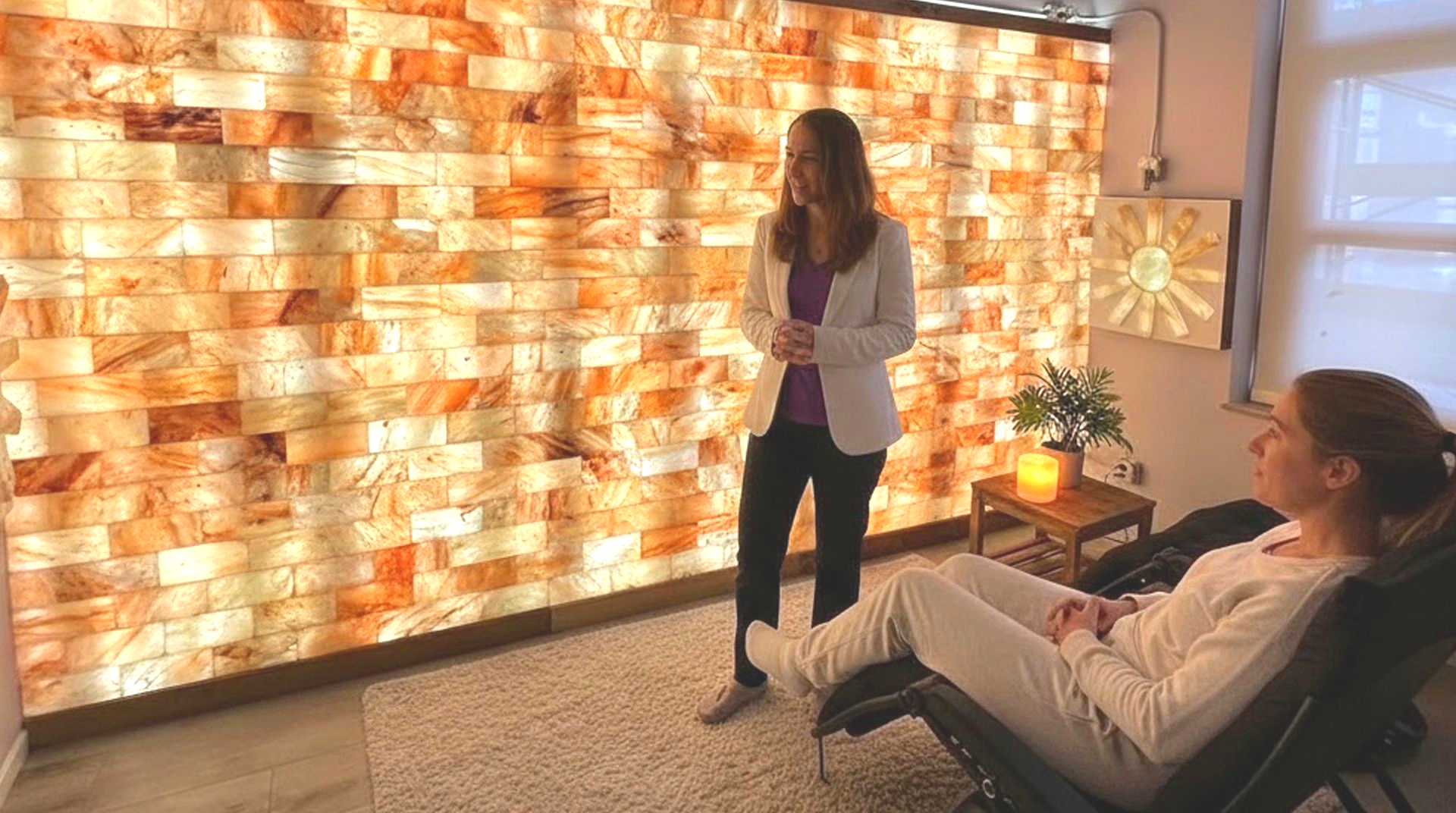 Dr. Alicia Armitstead explains to a patient why frequent respiratory infections keep coming back in her halotherapy salt room.