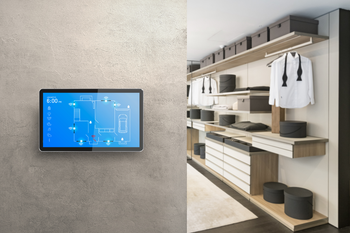 A smart tv is hanging on a wall next to a walk in closet.
