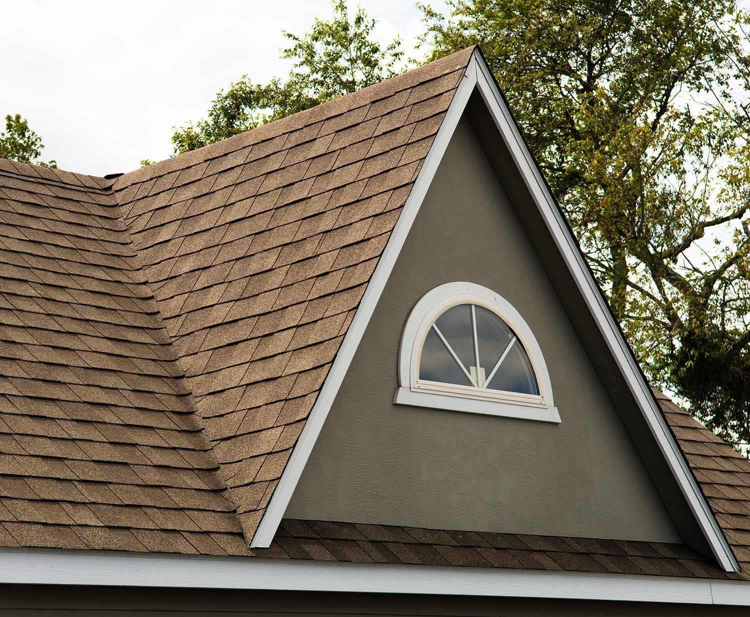 Brown shingled roof with an arched dormer window