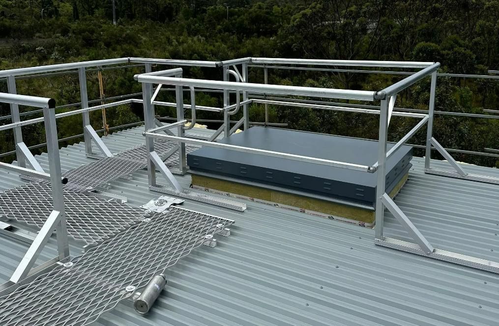 A Roof with A Metal Railing and A Skylight on It — Site Safety NSW in Port Stephens, NSW