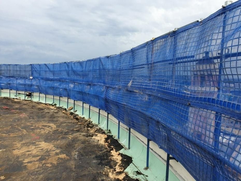 A Blue Fence Is Surrounding a Construction Site — Site Safety NSW in Sandgate, NSW
