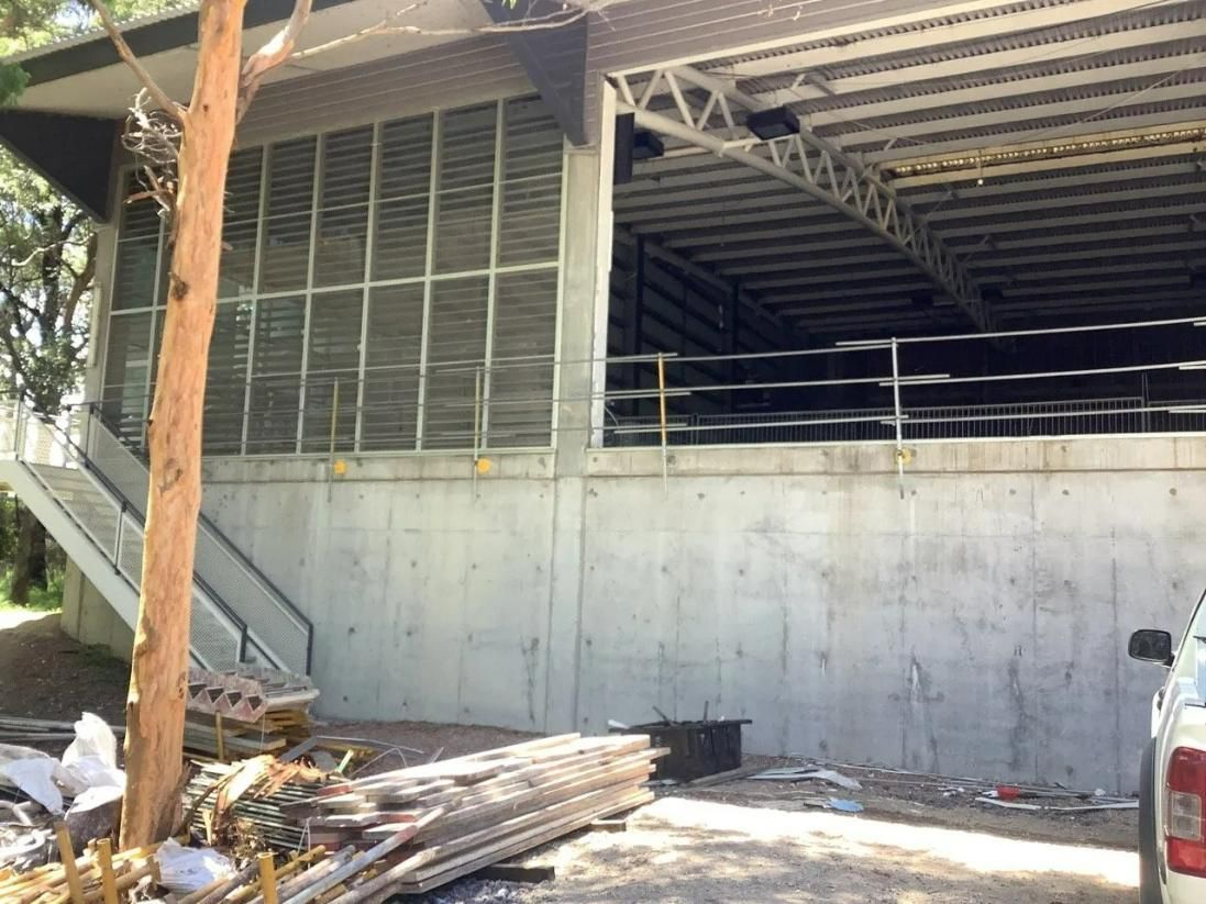 A Truck Is Parked in Front of A Building Under Construction — Site Safety NSW in Sandgate, NSW