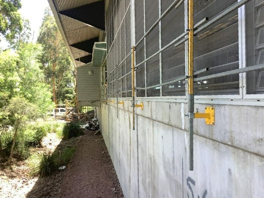 A Building with A Lot of Windows and A Concrete Wall — Site Safety NSW in Sandgate, NSW