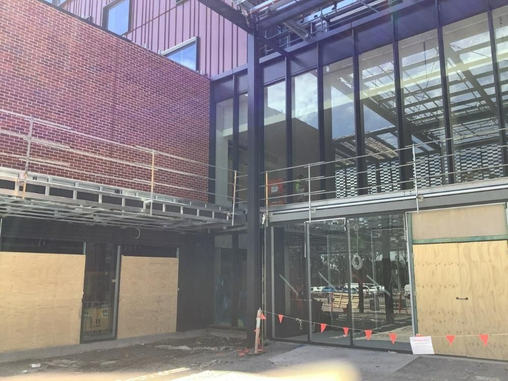 A Building Under Construction with A Lot of Windows and A Brick Wall — Site Safety NSW in Sandgate, NSW