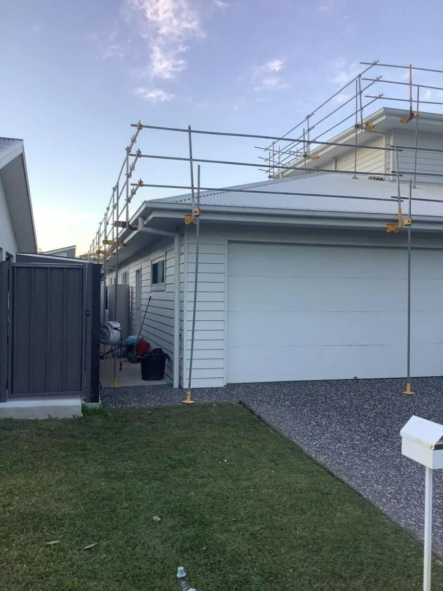 A House with Scaffolding on The Side of It and A Mailbox in Front of It — Site Safety NSW in Sandgate, NSW