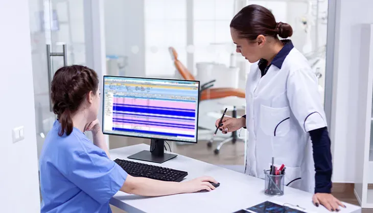 Doctors working on Practice Management Software
