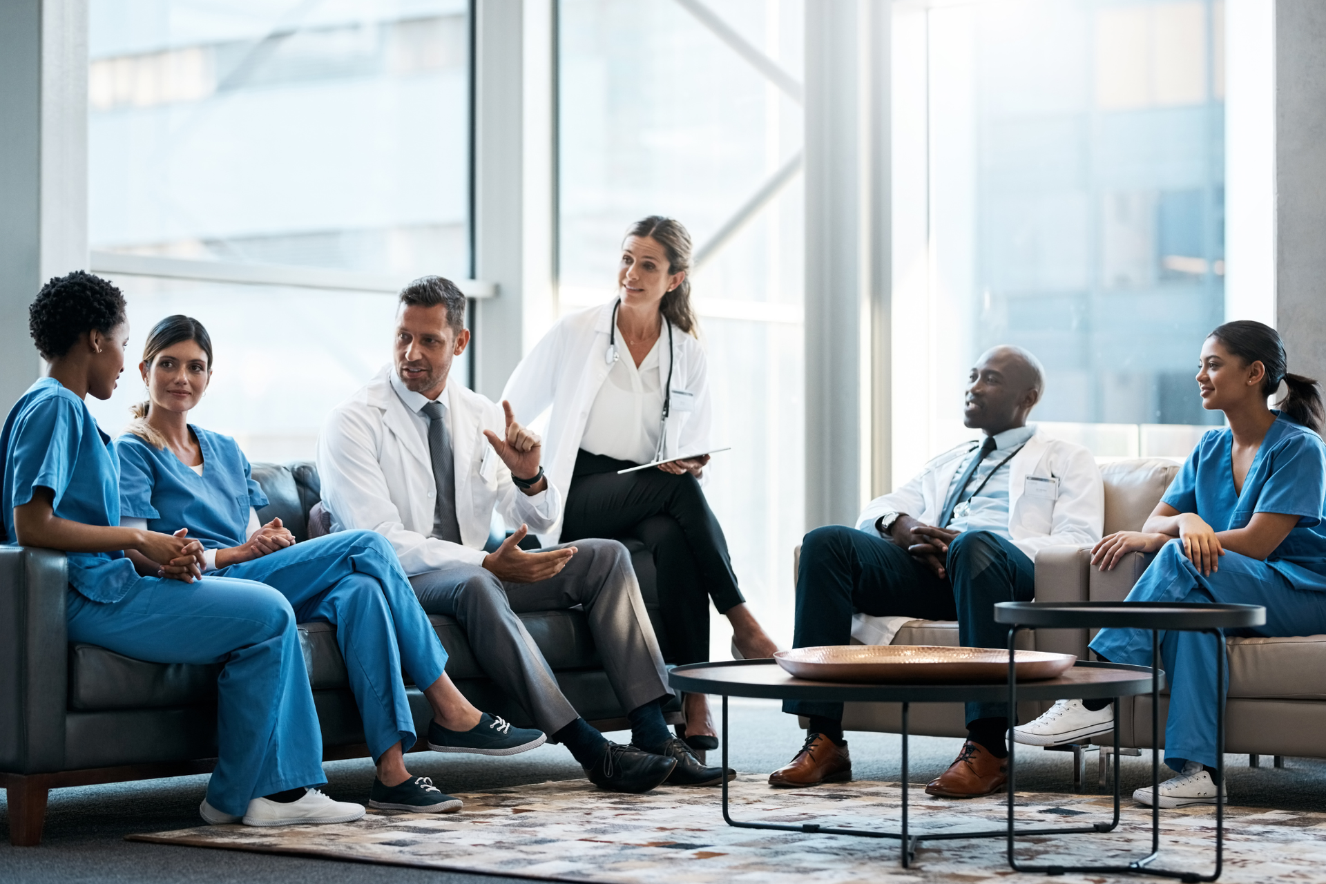 A medical team discusses strategies in their office, highlighting collaboration supported by AI healthcare solutions.