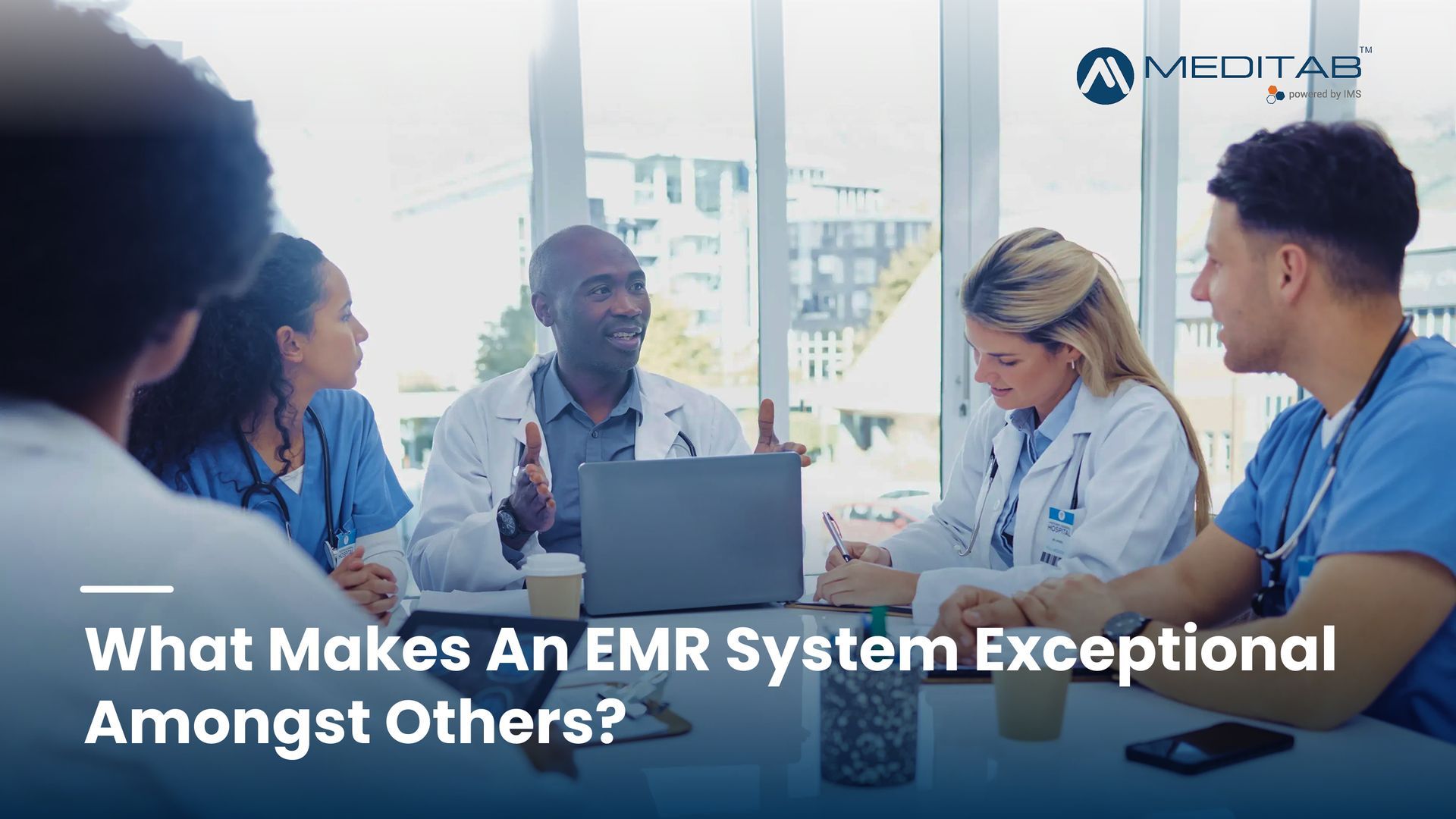 Healthcare leaders discussing and comparing EMR system options during a collaborative planning meeting