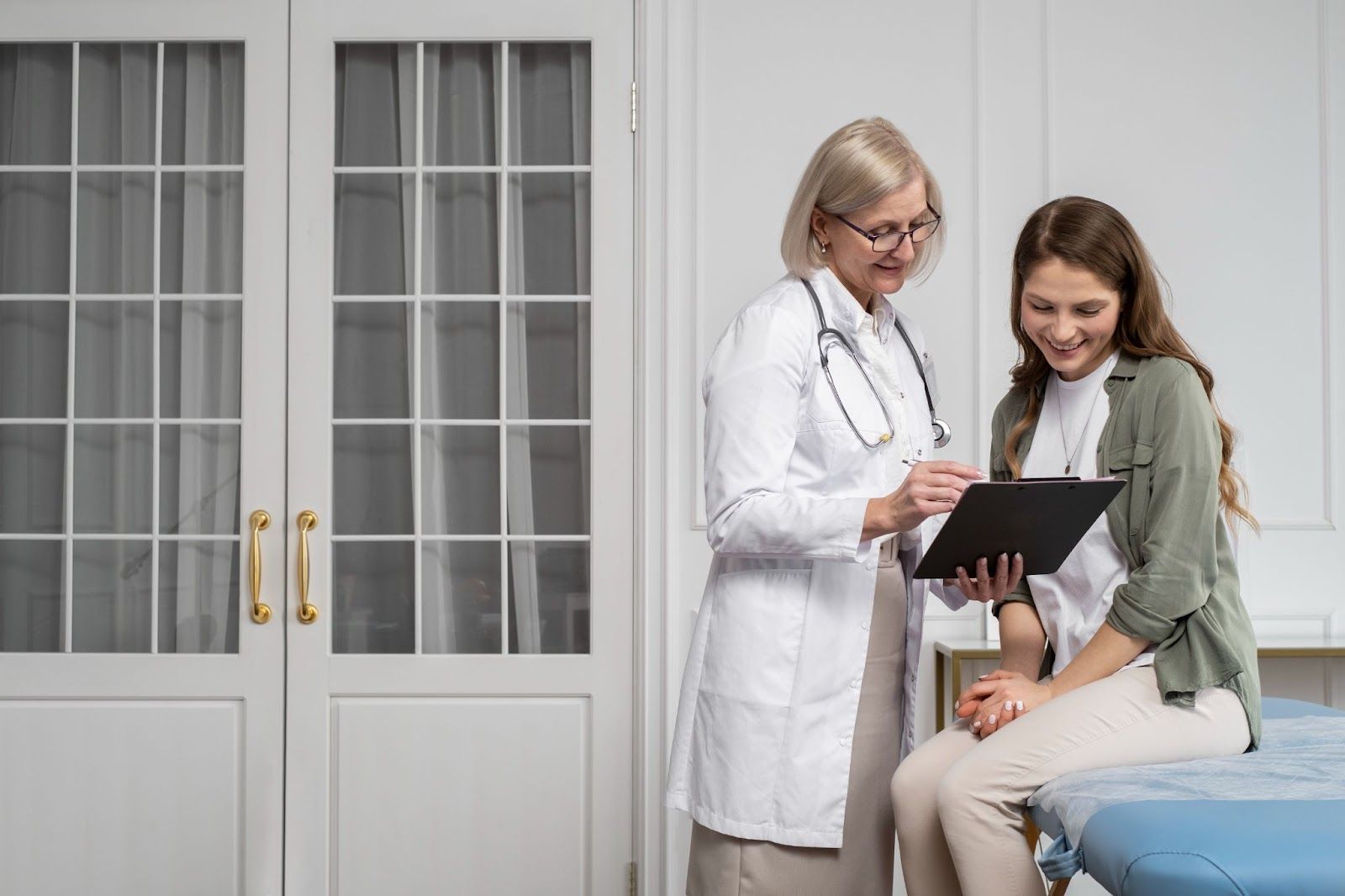 A woman and her doctor smile because of how easy it is to use IMS EasySign within the patient management software.
