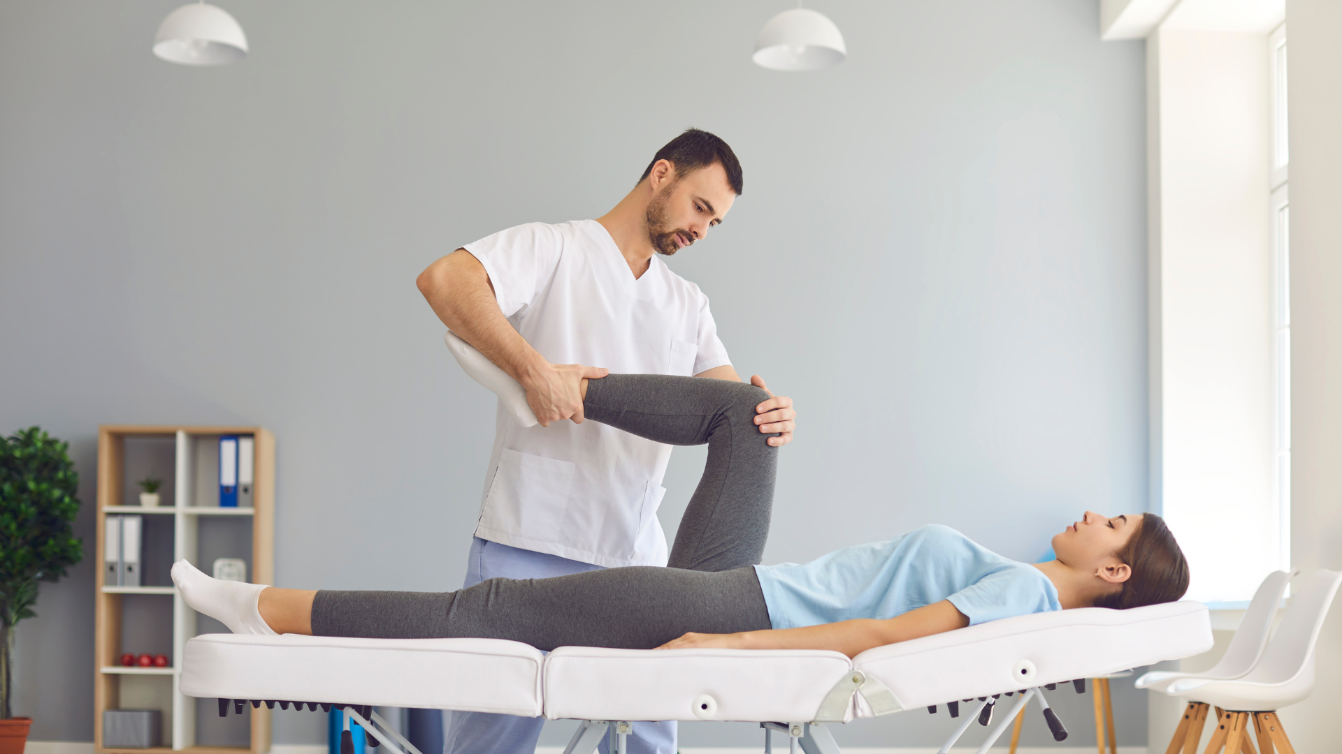 Doctor checking an injured foot wrapped in a white bandage