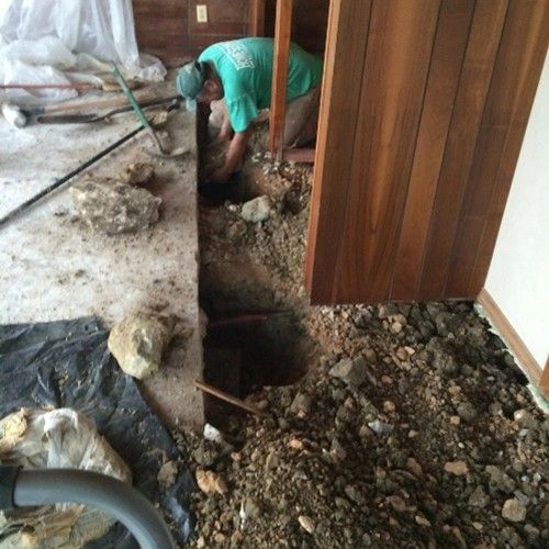 Experienced contractor working on professional concrete foundation repair services. Experienced contractor working on professional concrete foundation repair services.