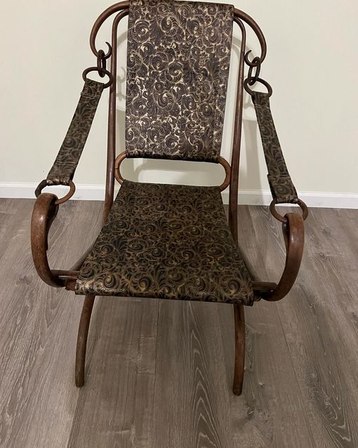 A chair is sitting on a wooden floor in a room.