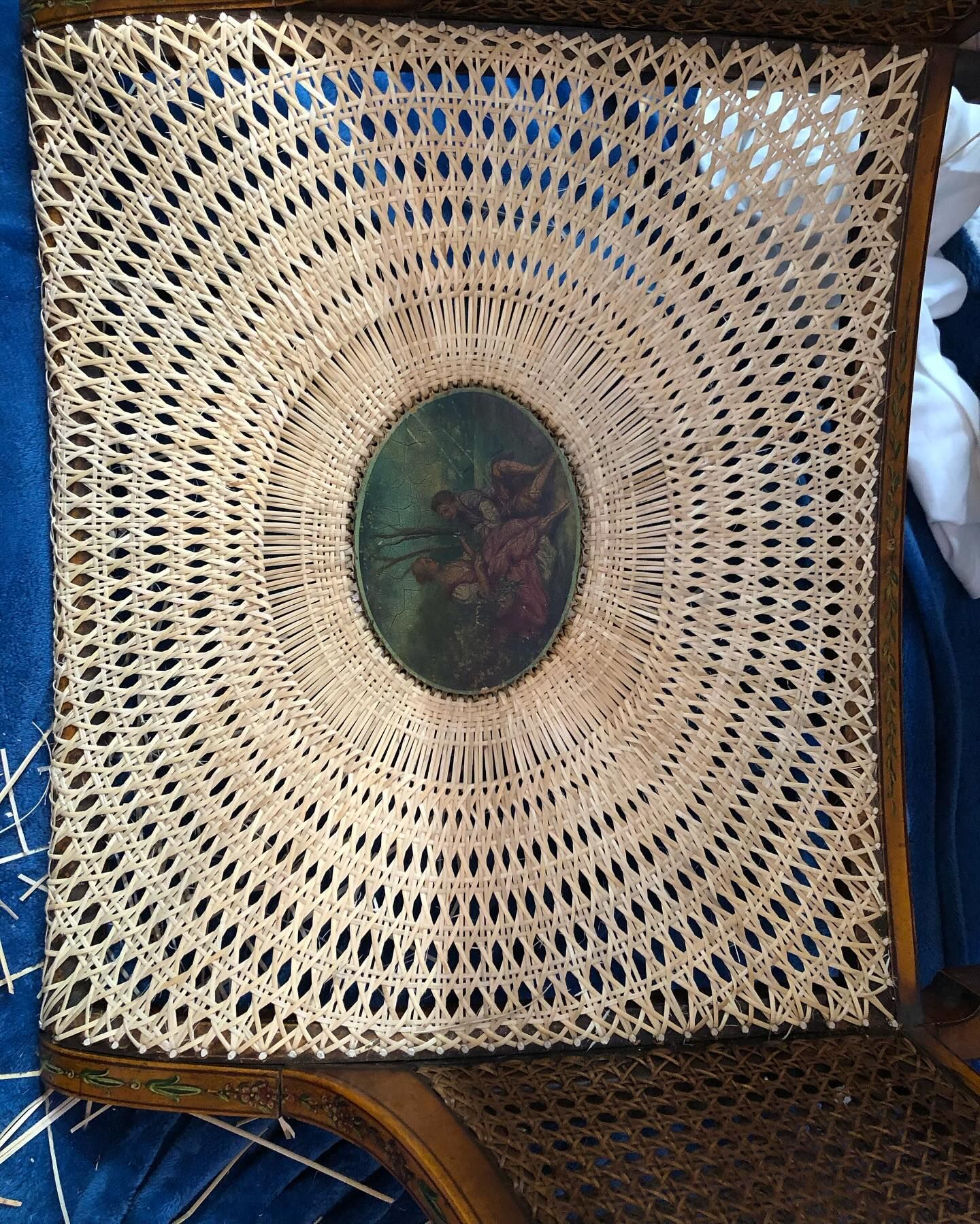 A wicker tray with a picture in the center