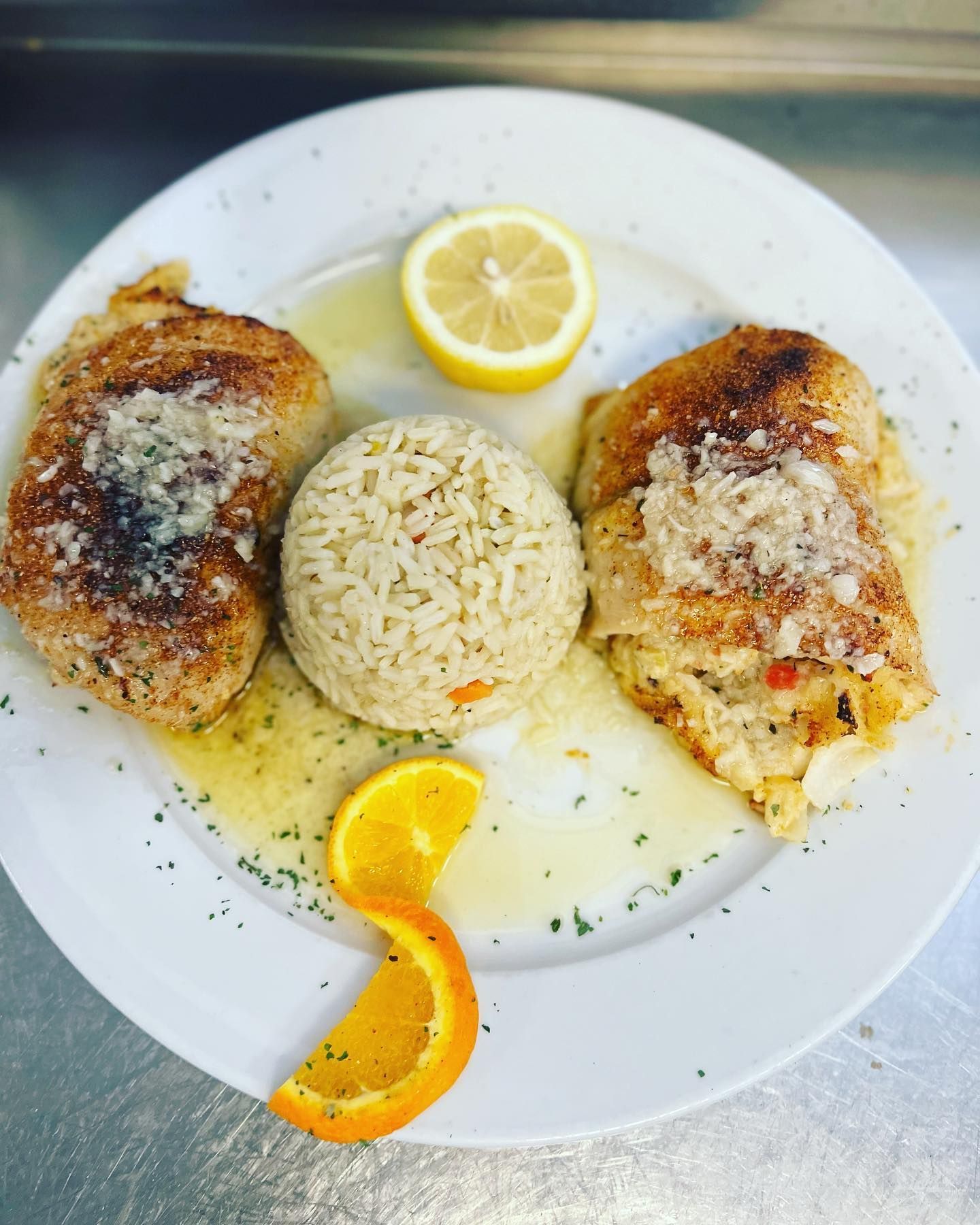 A plate of food with rice and a lemon slice
