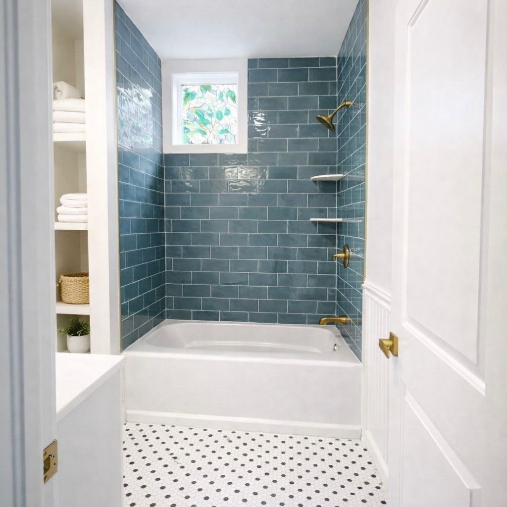Small bathroom with blue tile shower and white hexagon floor, seen through an open door.