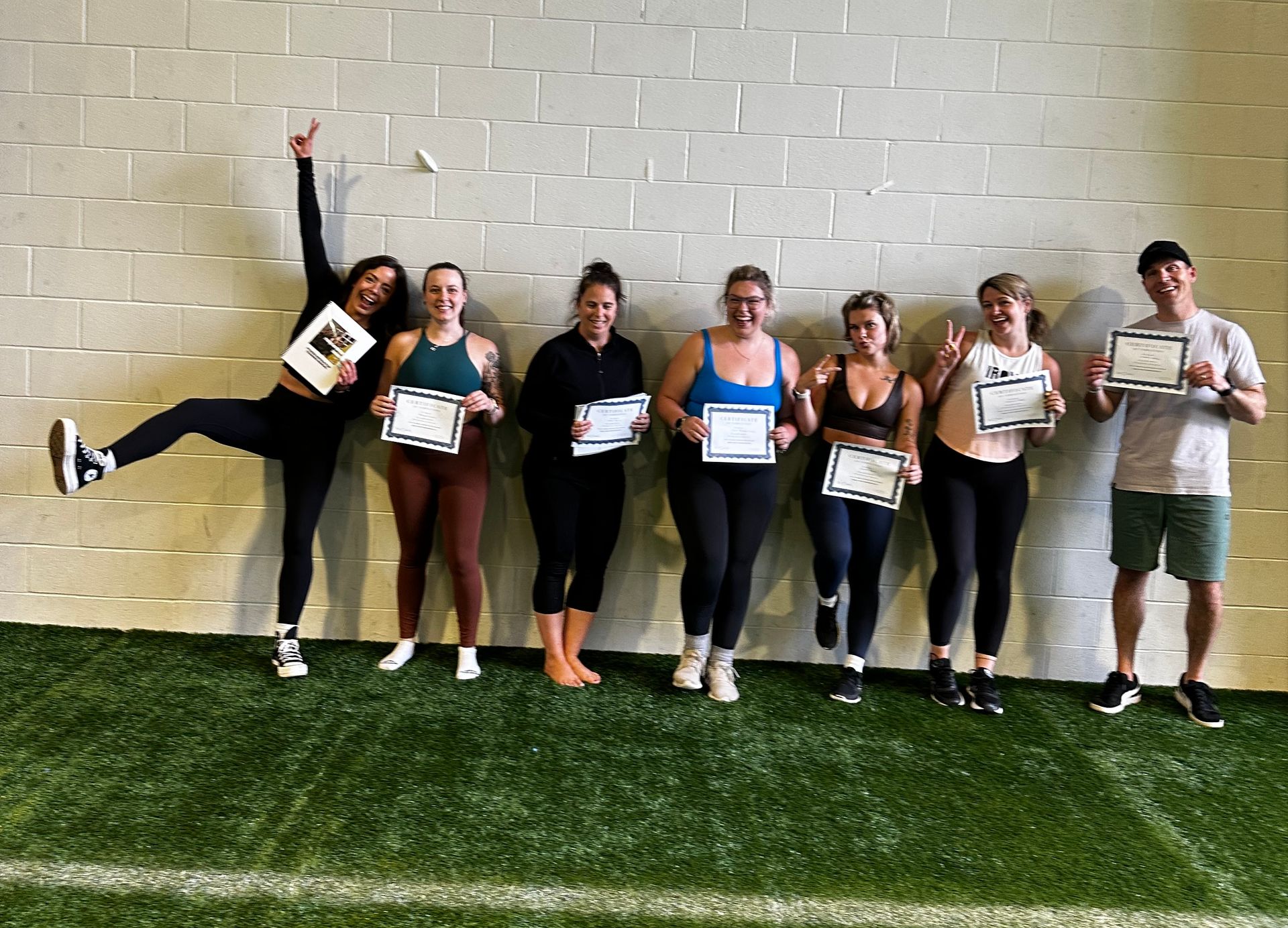 A group of people standing next to each other holding certificates.