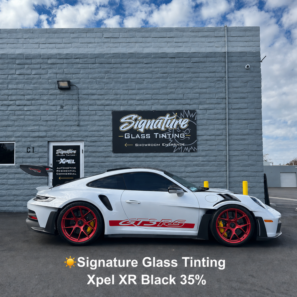 White Porsche with red wheels parked by Signature Glass Tinting building, with shop sign visible