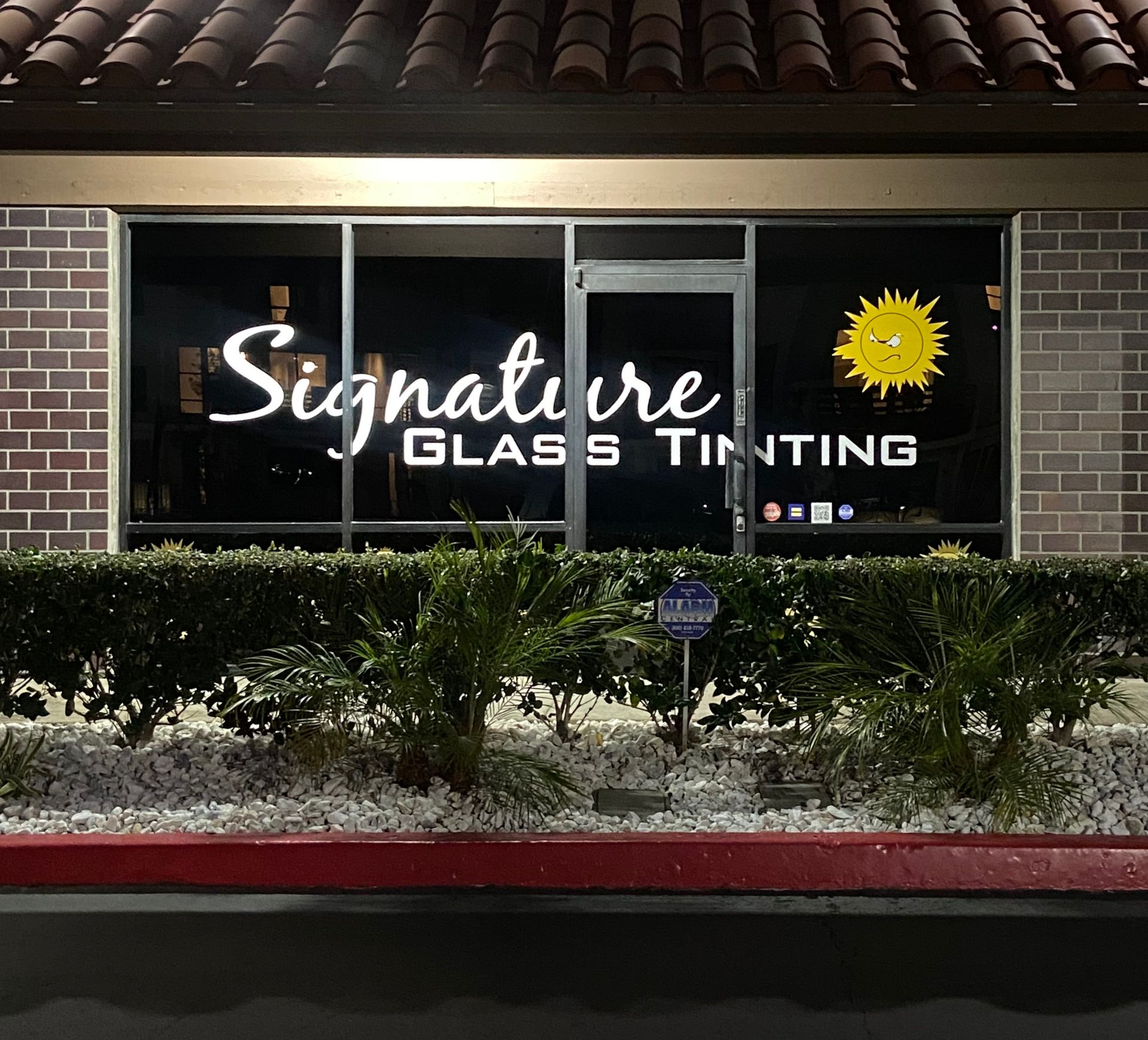 Car tinting shop reception with XPEL desk, Signature Glass Tinting sign, and blue bowl on counter Car tinting shop reception with XPEL desk, Signature Glass Tinting sign, and blue bowl on counter