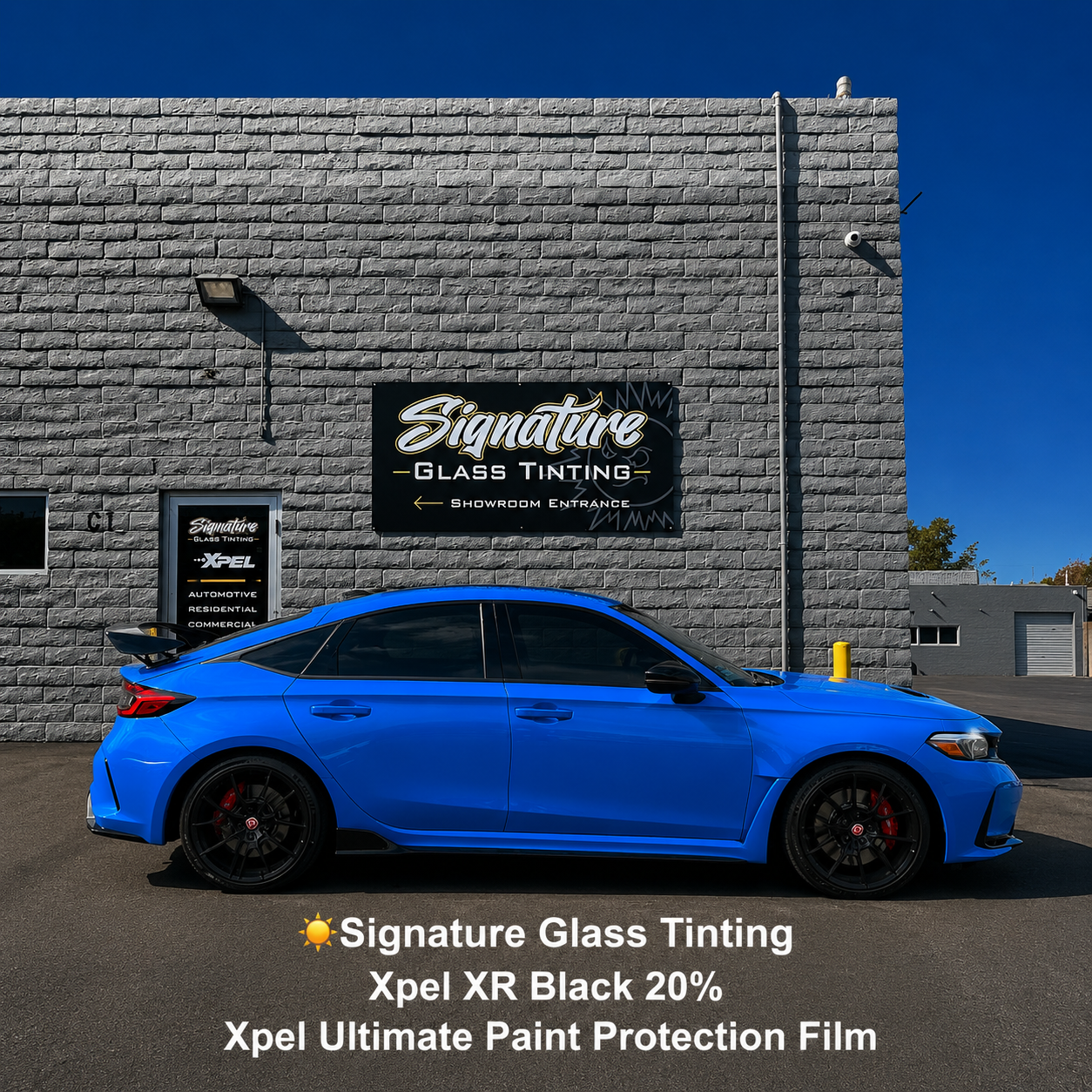 Blue sports sedan parked outside Signature Glass Tinting building with tinting promo text below