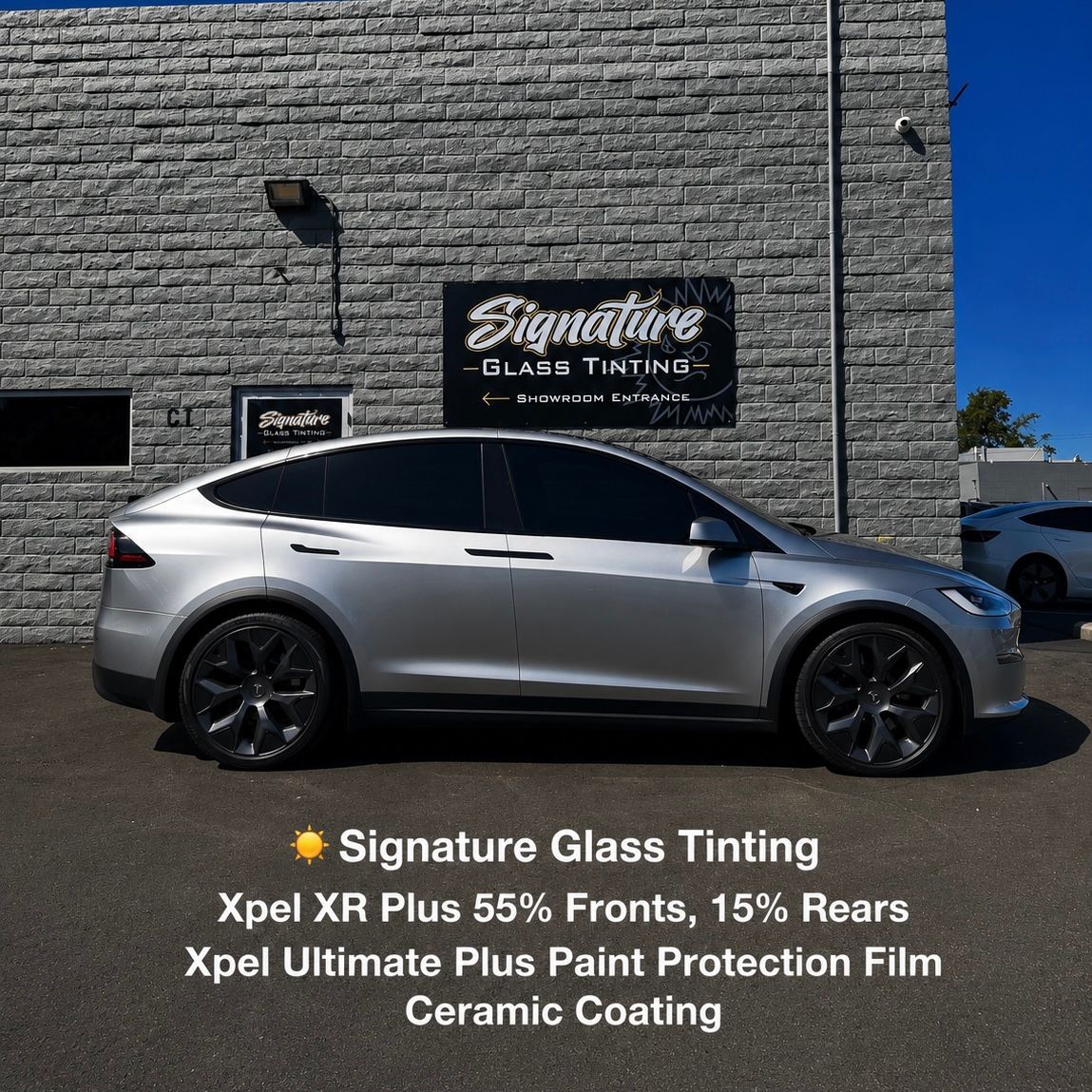 Silver sedan parked outside Signature Glass Tinting shop with promotional text overlay on film services