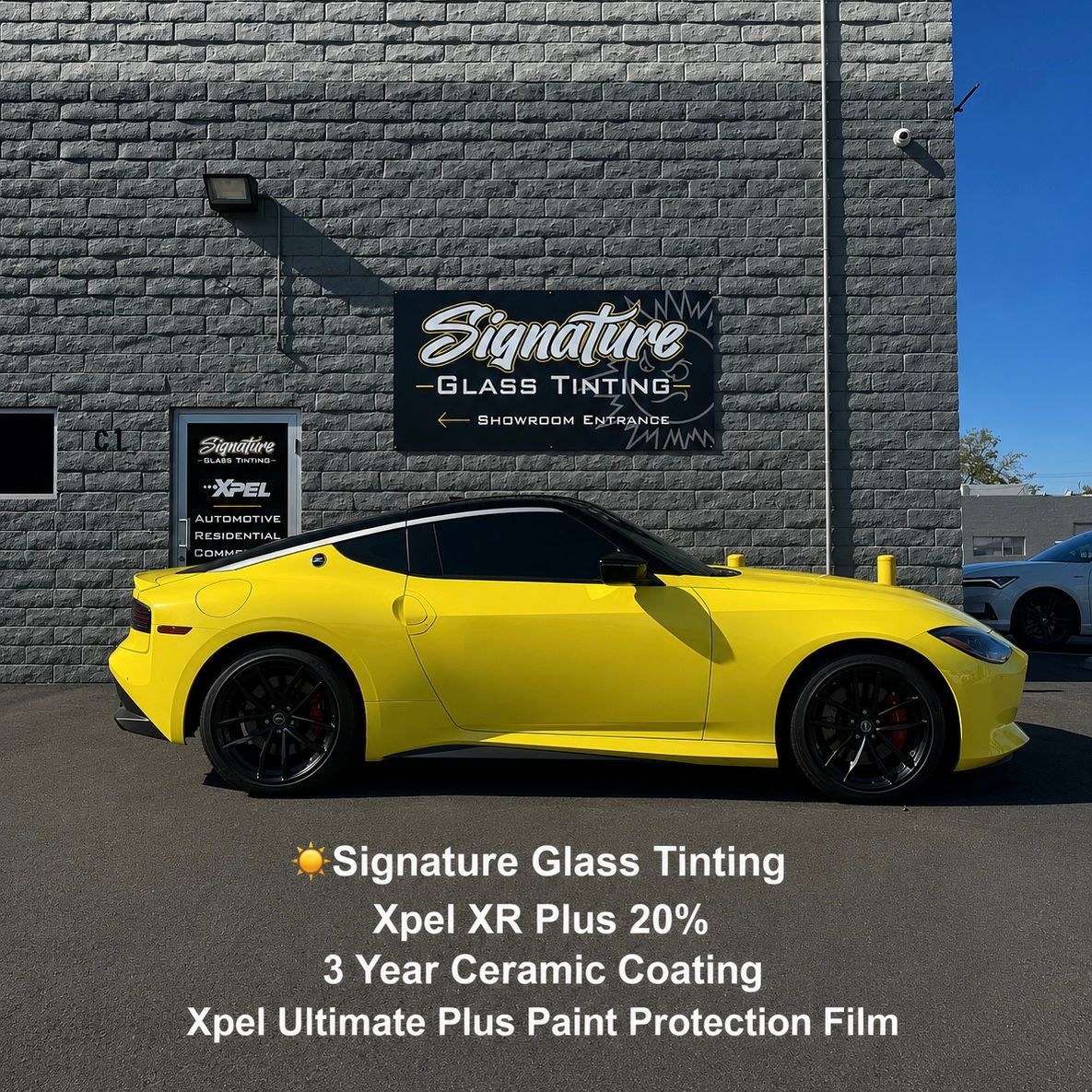 Yellow sports car parked outside Signature Glass Tinting shop with service sign and window film text.