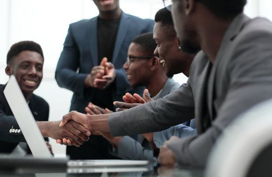 Car accident lawyer shaking hands with a client, discussing legal matters related to the accident