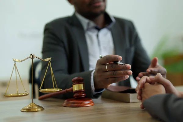 Attorney discussing an auto accident case with a client. Attorney discussing an auto accident case with a client.