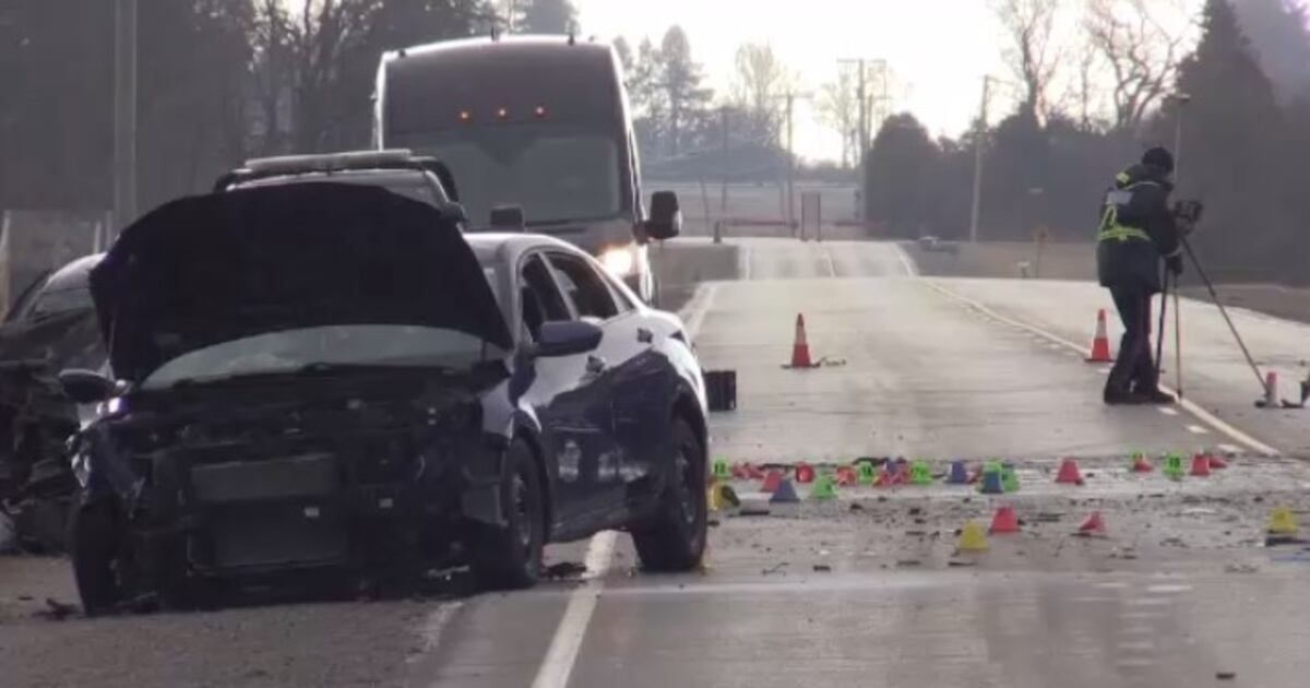 Car accident on the road with damaged vehicle, surrounded by orange traffic cones marking the scene