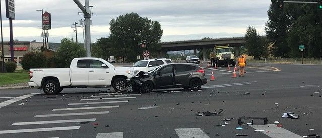 A car accident surrounded by orange cones to mark the scene