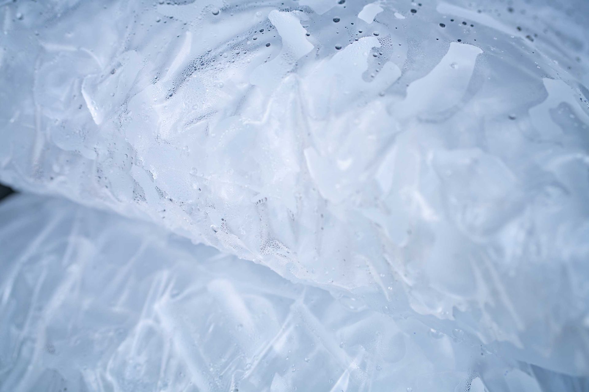 Close-up of tube ice inside two clear plastic bags. Close-up of tube ice inside two clear plastic bags.