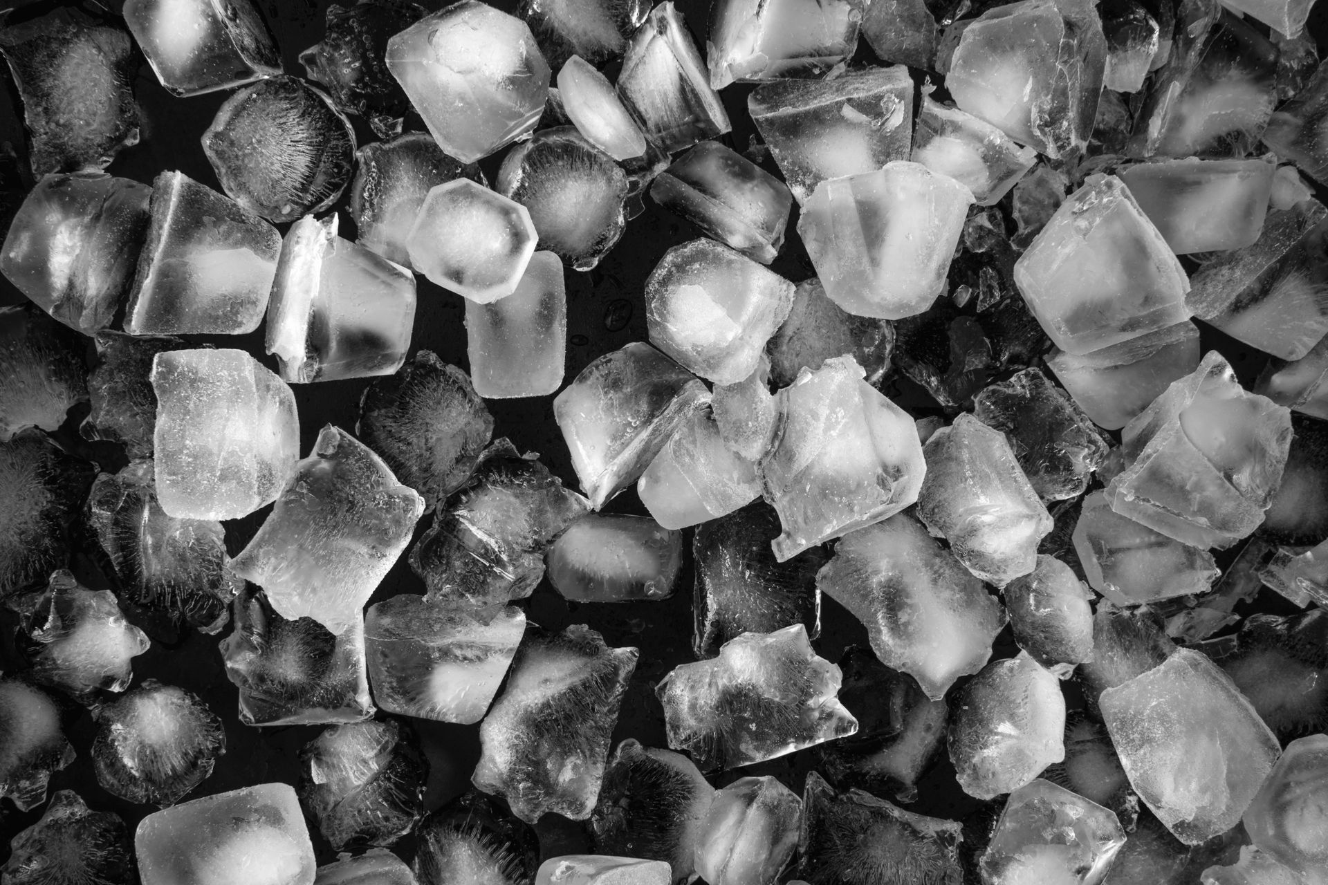 Close-up of assorted ice cubes with frosty textures, clear edges, and frozen crystalline details. Close-up of assorted ice cubes with frosty textures, clear edges, and frozen crystalline details.