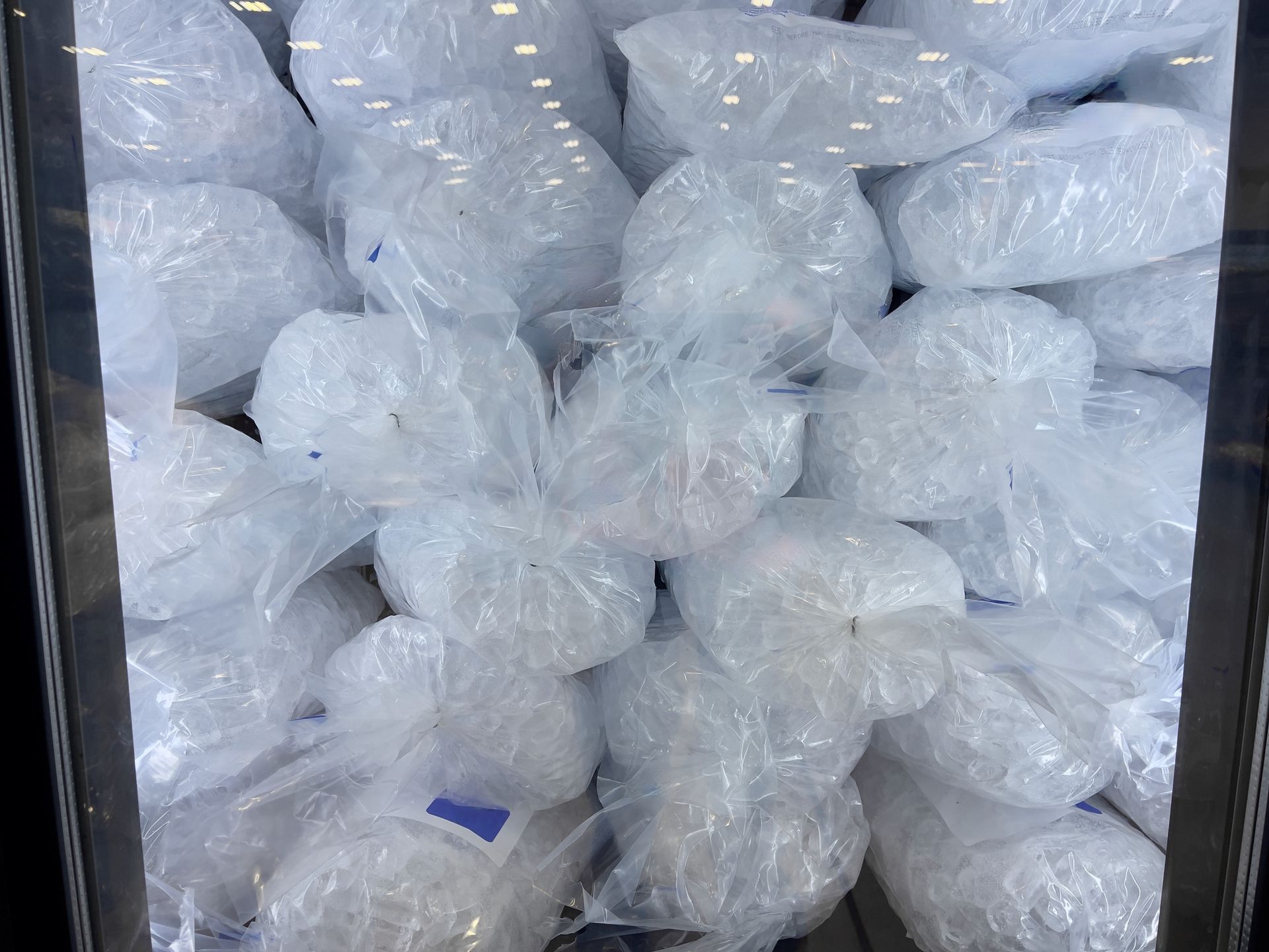 A freezer stocked with crystal-clear bagged ice from Ice Plant Inc., the trusted wholesale ice suppl