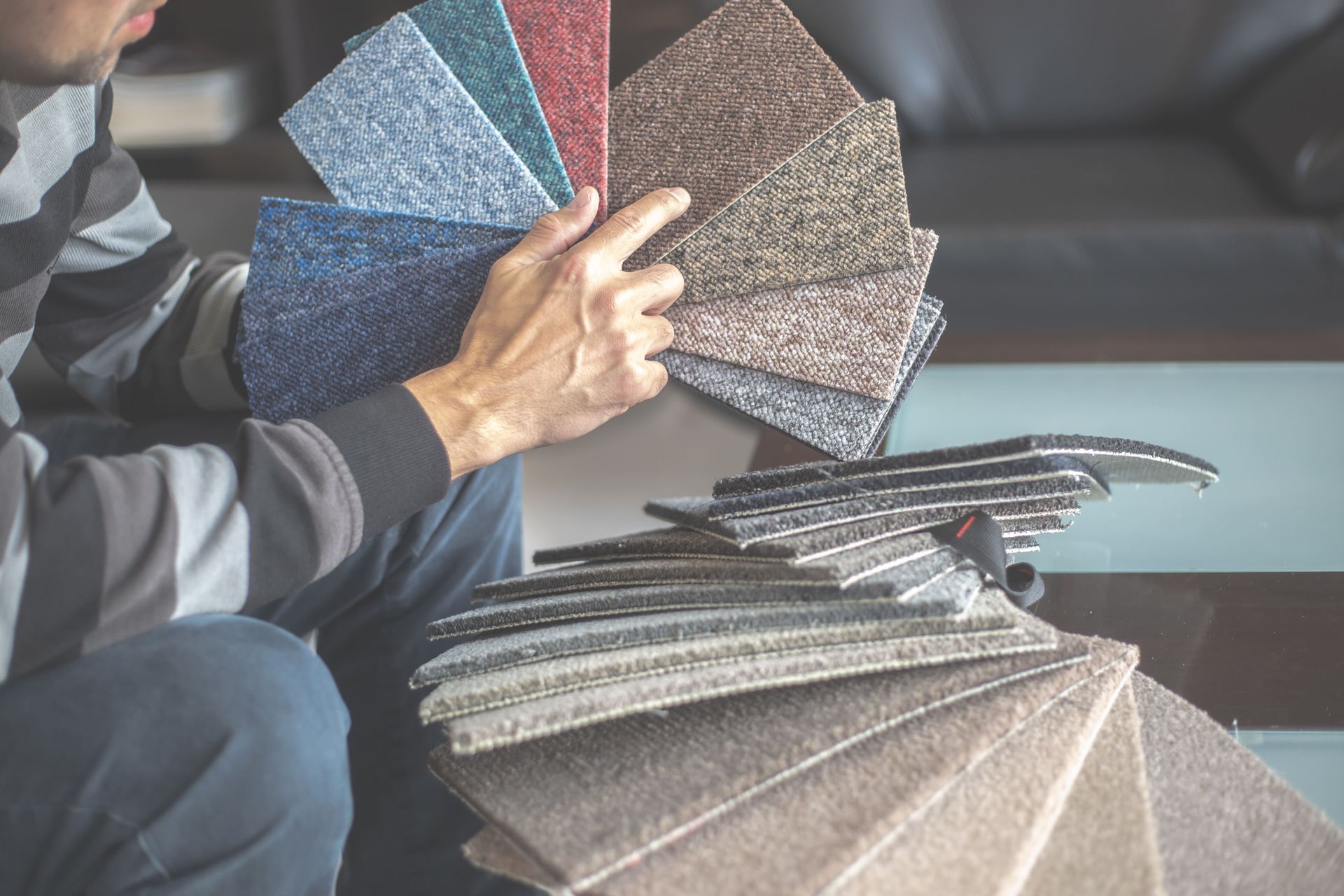 a person holding carpet samples for Kennewick customer 