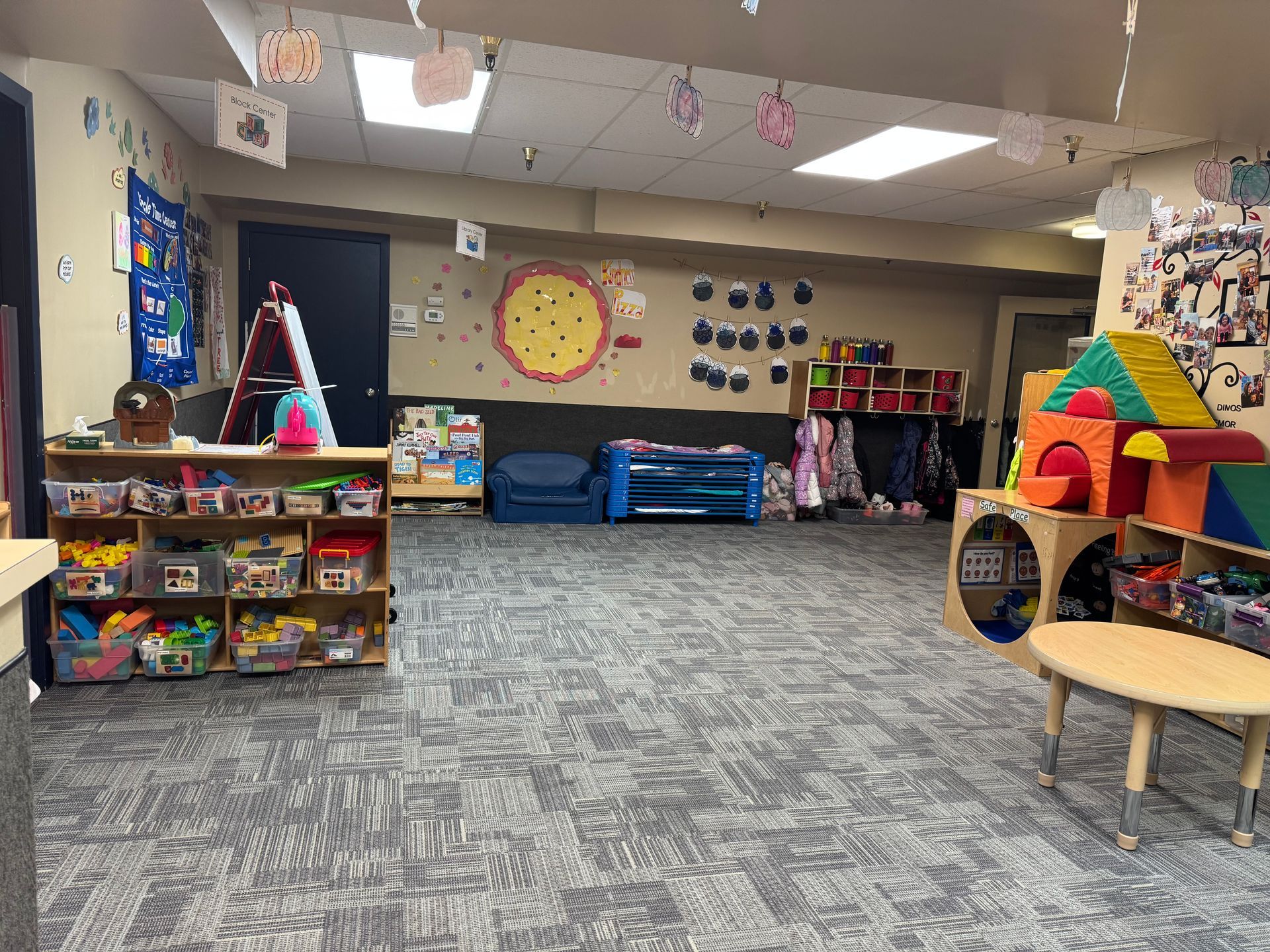 A classroom interior with toys, books, and educational decorations.