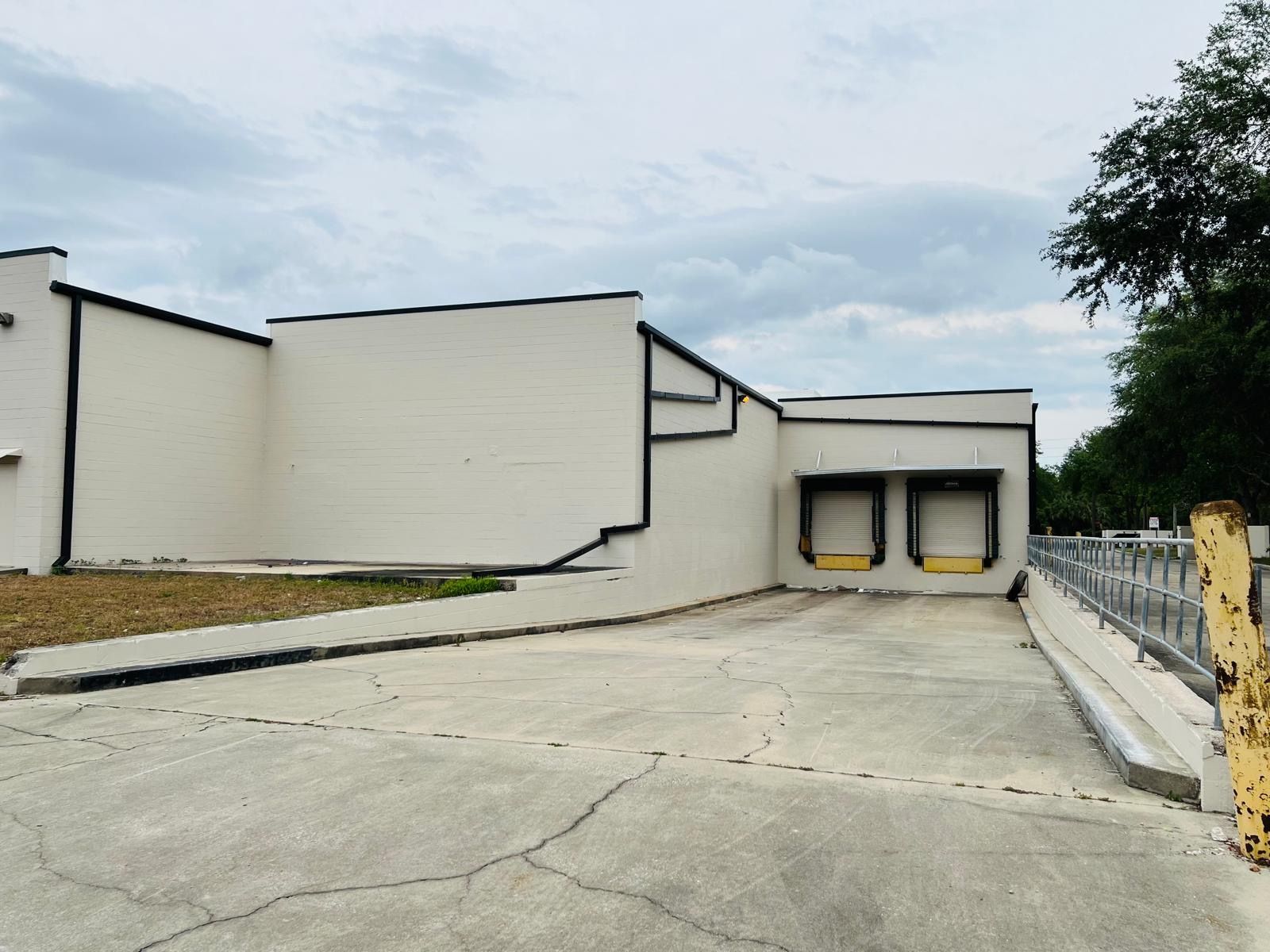 A large white building with a loading dock in front of it