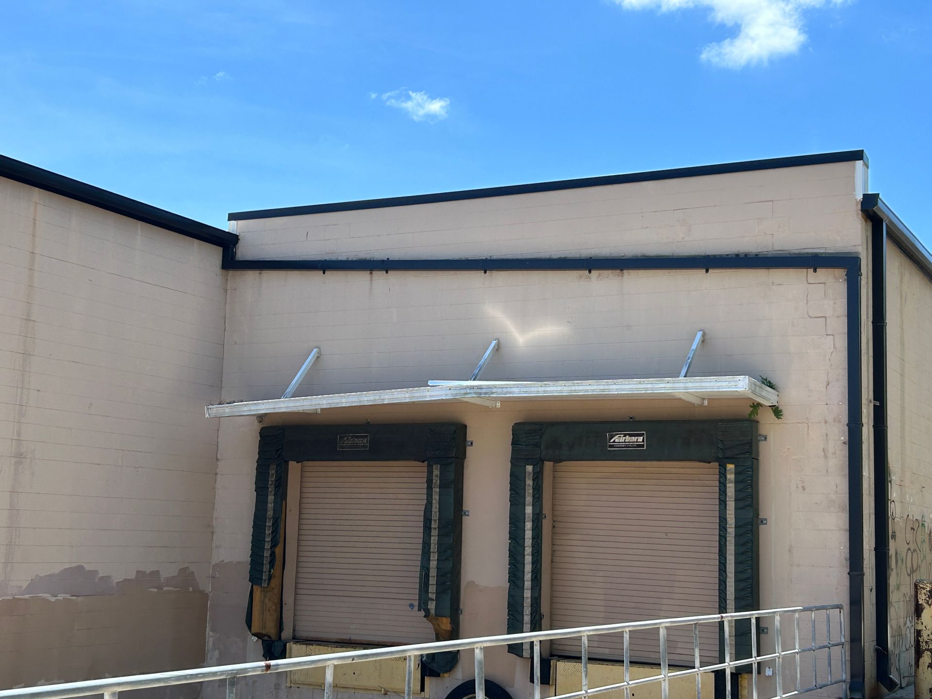 A warehouse with a canopy over the loading doors