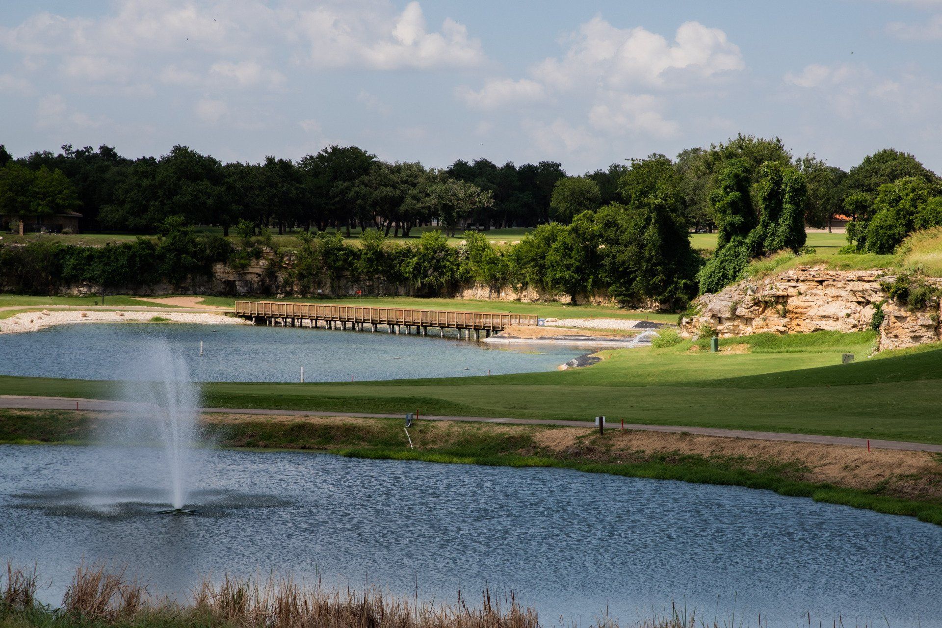 A golf course with a fountain in the middle of it