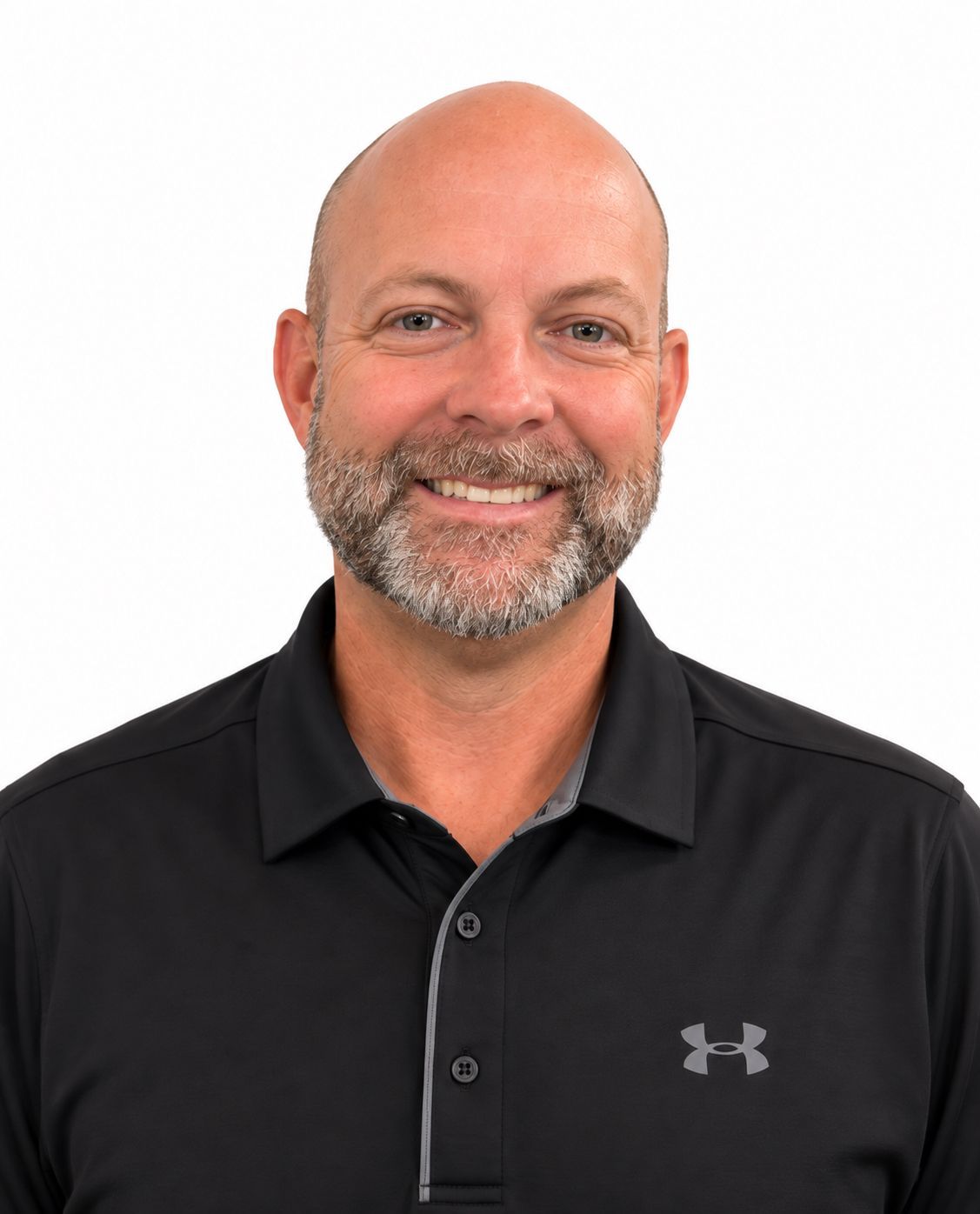 A bald man with a beard is wearing a black under armour polo shirt.