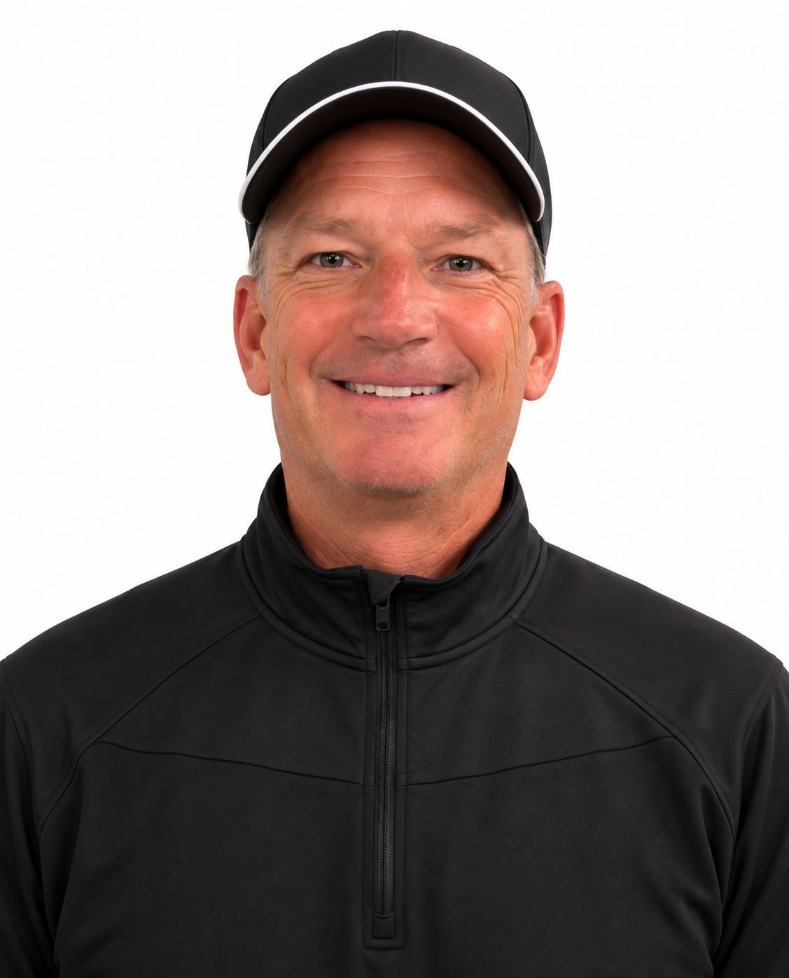 A man wearing a hat and a black sweater is smiling for the camera.