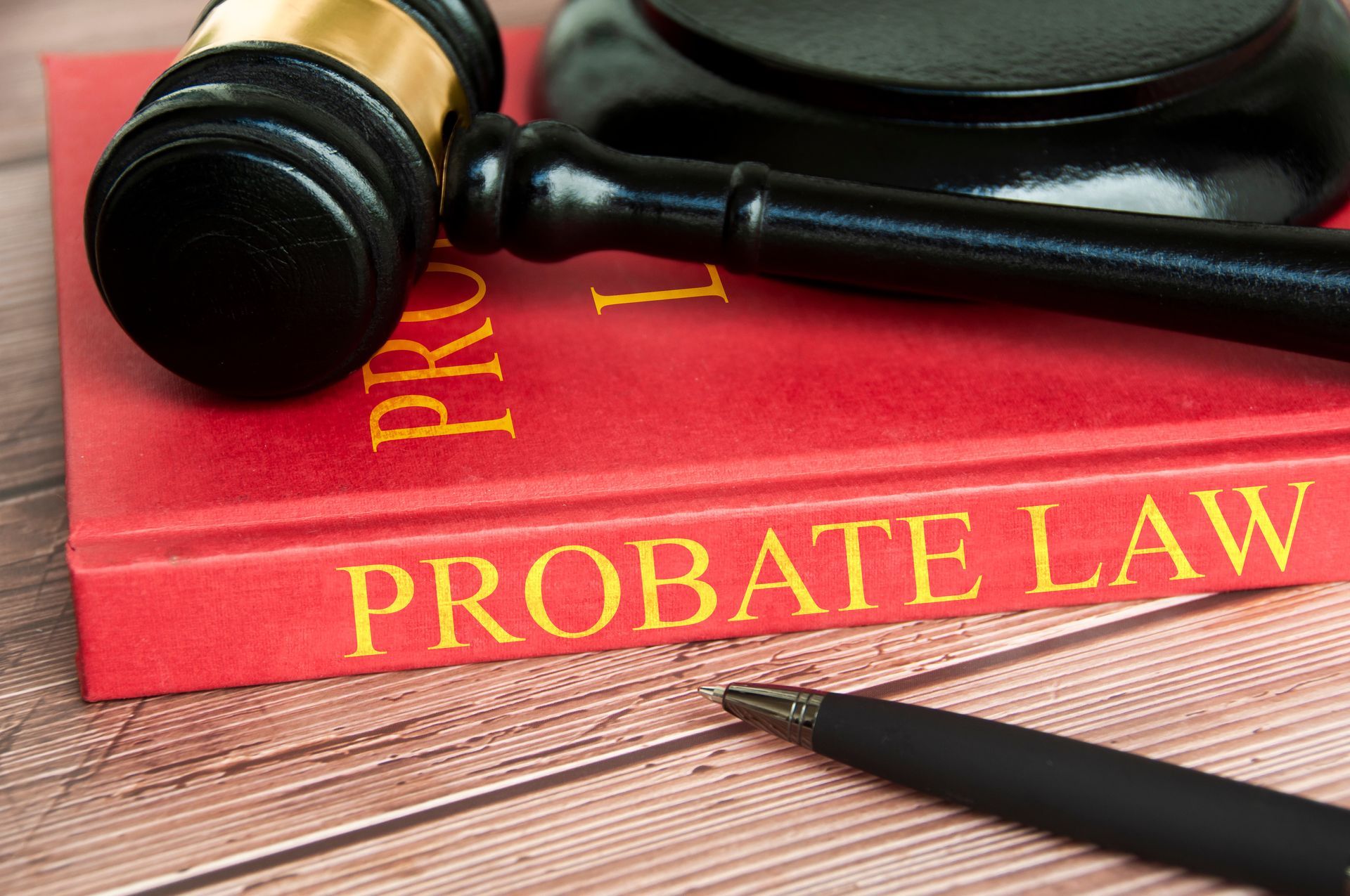 Gavel on a probate law book with a legal document pen