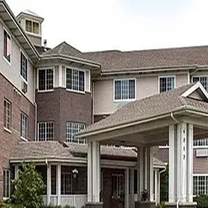 Brick apartment building entrance with covered driveway and windows