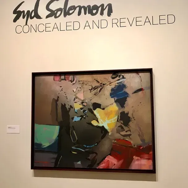 A painting in a gallery with the title 