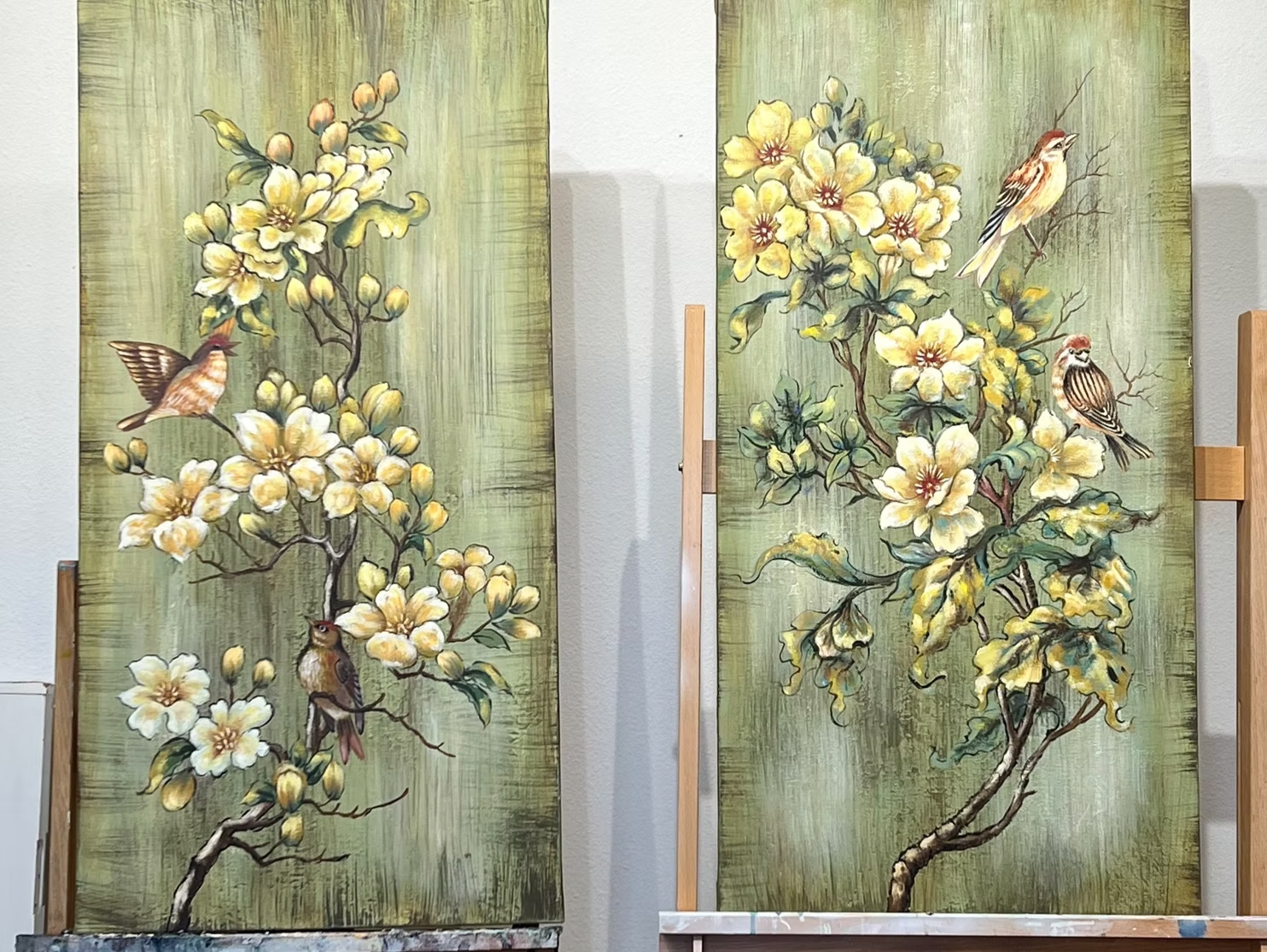 Two floral paintings with birds. Yellow flowers and birds on green textured background.