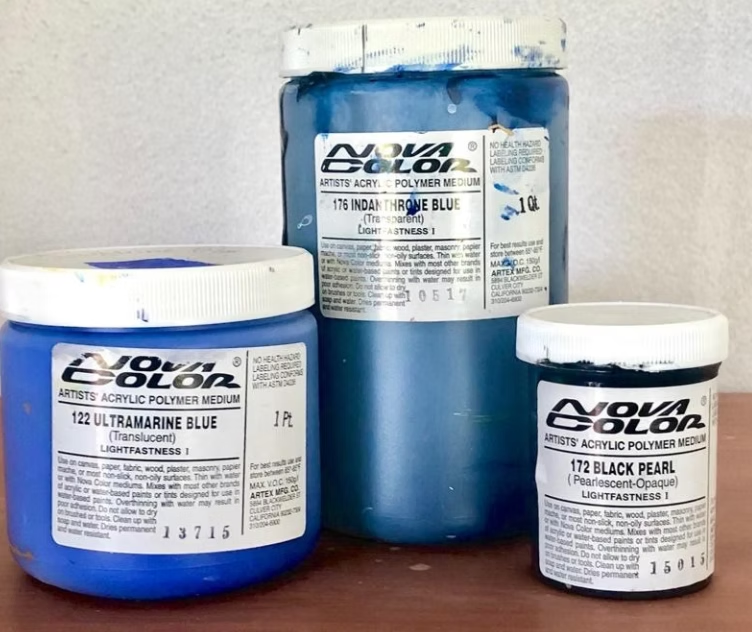 Three jars of Nova Color acrylic paint: ultramarine blue, indigo, and black pearl.