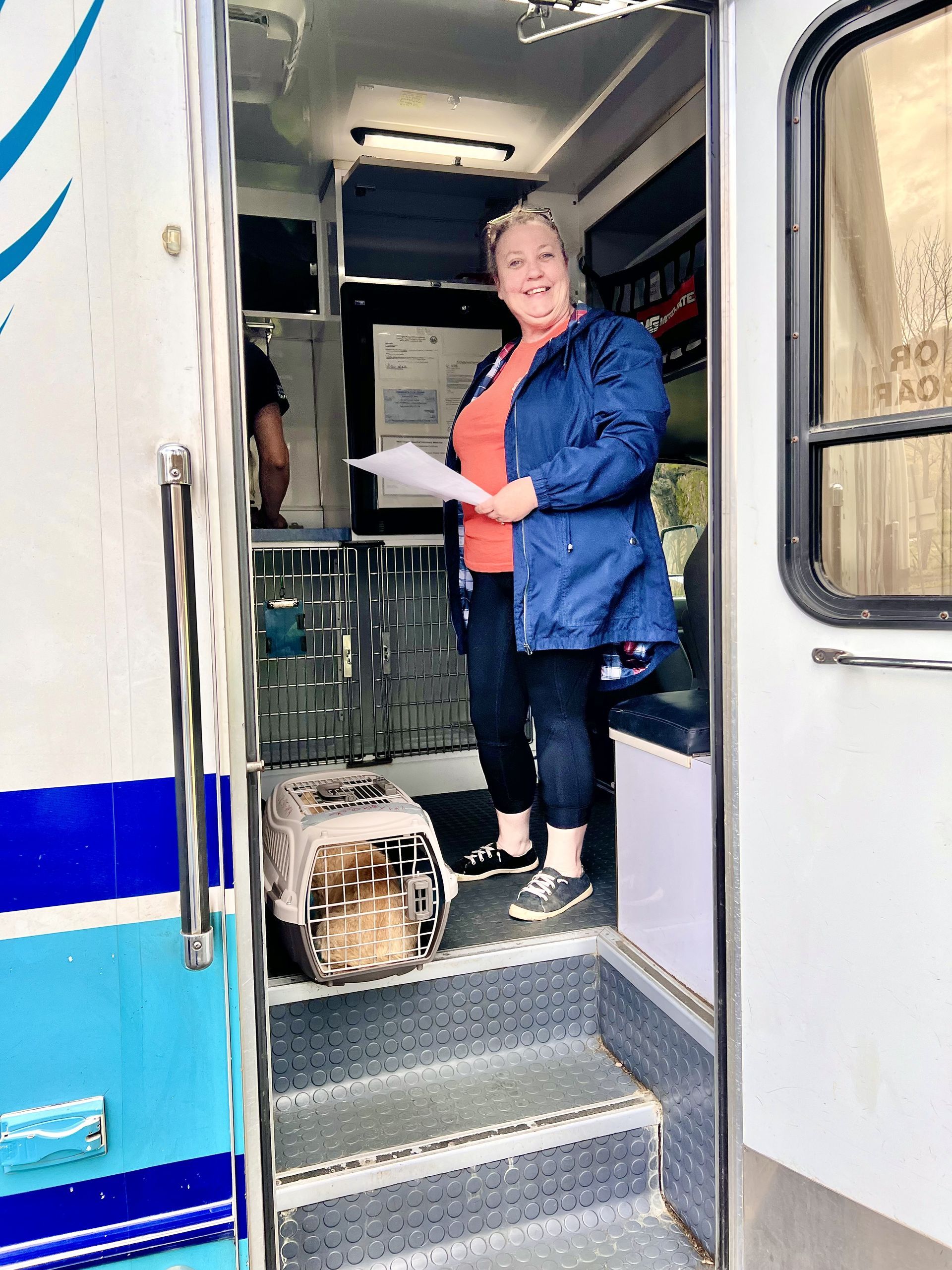Volunteer petting a dog at a community event