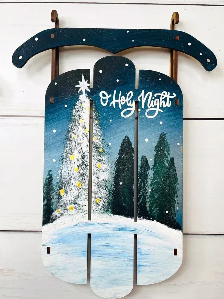 Winter porch sign reading “O Holy Night” with snowy trees and a starry night scene